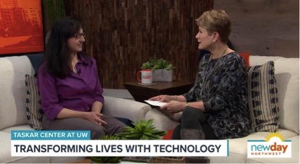 Anat Caspi sits on a couch opposite the host of New Day NW