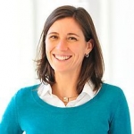 Headshot of Leah Findlater, smiling warmly. She is a white woman with brown hair.