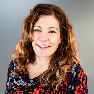 Olivia Banner, a white woman with a warm smile and smiling eyes.